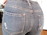 Cute curly haired blonde farting in jeans